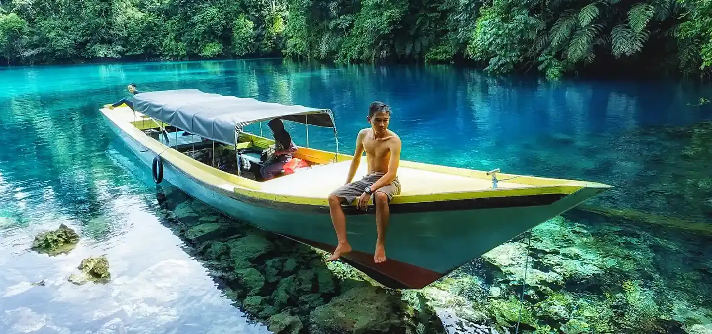 Longboat on the clear water of Labuan Cermin
