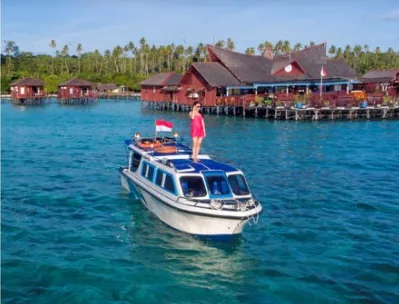 Speedboat in front of red-roofed over-water cottages